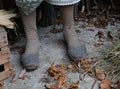 old worn-out slippers at the feet of an old old woman on  the rural house Royalty Free Stock Photo