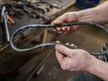 Old worn rubber alternator belt in men`s hands. The concept of car maintenance. Copy space