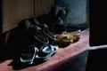 Old worn shoes in the beam of light. A lot of old shoes in a dark room Royalty Free Stock Photo