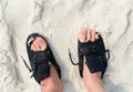 Old worn shoes on feet with human finger in holes Royalty Free Stock Photo