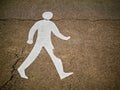 Old worn sign of human on a asphalt in a park, Crack goes through the neck, Concept danger, death, warning Royalty Free Stock Photo