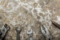 Old worn tool on rumpled shabby metal, close-up abstract background