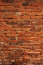 Old worn vertical brick wall
