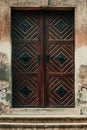 Old worn wooden door with symmetrical diamond pattern Royalty Free Stock Photo