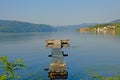 Old worn wooden pier in Danube river in early morning light