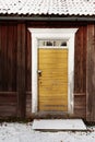 An old worn yellow wooden door