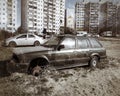 Old wreck of BMW 320 hatchback abandoned and left in sand and grass Royalty Free Stock Photo