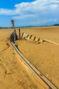 Old wreck fishing boat buried in the sand with blue sky on cloud Royalty Free Stock Photo