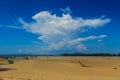 Old wreck fishing boat buried in the sand with blue sky on cloud Royalty Free Stock Photo