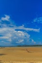 Old wreck fishing boat buried in the sand with blue sky on cloud Royalty Free Stock Photo