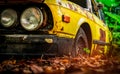 Old wrecked car in vintage style. Abandoned rusty yellow car in the forest. Closeup front view headlights of rusty wrecked abandon Royalty Free Stock Photo