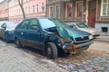 Old wrecked dark green compact car Skoda Favorit left on a street