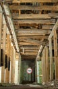 Old wrecked house with 'Danger' in English and in Ukrainian warning sign, abandoned building, uninhabitable place