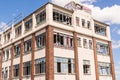 Old, wrecked and ruined industrial building with broken windows