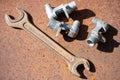 Old spanner on aOld wrench and metal parts on a rusty sheet of metal, close-up, selective focus. rusty sheet of metal