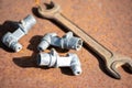 Old spanner on aOld wrench and metal parts on a rusty sheet of metal, close-up, selective focus. rusty sheet of metal