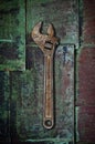 Old wrench on rusty surface. Royalty Free Stock Photo