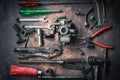 Old wrench and tools and carburetor on rusty background . moto