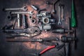 Old wrench and tools and carburetor on rusty background . moto