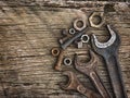 Old wrenches on the nuts and bolts on a wooden grungy background Royalty Free Stock Photo