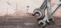 Old wrenches on a wooden desk with copy space