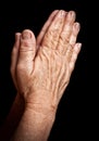 Old wrinkled hands praying Royalty Free Stock Photo