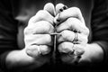 Old wrinkled woman hands holding a rosary. Closeup of christian  woman hands holding rosary while praying God Royalty Free Stock Photo