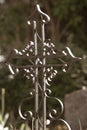 Old wrought iron cross next to the grave Royalty Free Stock Photo