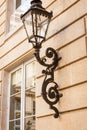 Old wrought iron lamp on a building exterior