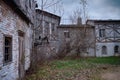 Old yard overgrown with trees and bushes with houses in the style of medieval Europe. Retro buildings in an ancient European city Royalty Free Stock Photo