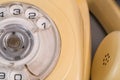 Old yellow antique rotary telephone with removed handset receiver on grey background. Vintage landline home phone with Royalty Free Stock Photo