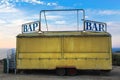 Old Yellow Bar Trailer vehicle with word Bar partially broken