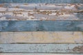 Old yellow blue white wooden wall fence of wooden boards with peeling paint. horizontal lines. rough surface texture Royalty Free Stock Photo