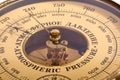 Old yellow-brown aneroid barometer in wooden body close-up Royalty Free Stock Photo