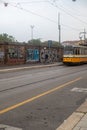 an old yellow bus is traveling past a graffiti covered fence Royalty Free Stock Photo