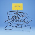 Old yellow cassette with the ribbon tangled underneath Royalty Free Stock Photo