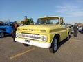 old yellow 1965 Chevrolet Chevy C10 Apache Flareside bed pickup truck in a parking. Classic car show Royalty Free Stock Photo