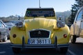 Old yellow Citroen 2CV parked outside