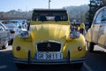 Old yellow Citroen 2CV parked outside