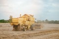 Old yellow combine harvesting wheat on the field Royalty Free Stock Photo