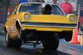 Old yellow drag car popping wheelies in Steele city, Nebraska, United States Royalty Free Stock Photo