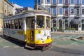 old yellow electric vehicle on rails typical of the Portuguese city of Lisbon, career nÂ°28, Martim Moniz