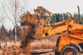 An old yellow excavator helps to set up the road in the village