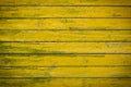 Old yellow-green wooden painted planks. Abstract background Royalty Free Stock Photo