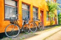 Old yellow house of Nyboder district with bicycles. Old Medieval district in Copenhagen, Denmark. Summer sunny day Royalty Free Stock Photo