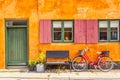 Old yellow house of Nyboder district with a red bicycle. Old Medieval district in Copenhagen, Denmark Royalty Free Stock Photo