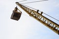 Old yellow mechanical clamshell grab on blue sky background