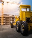 Old yellow motor grader on the road Royalty Free Stock Photo