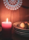 Old yellow painted cupboard with candles, autumn leaves and crocheted doilies Royalty Free Stock Photo