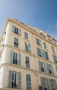 Old Yellow Plaster French Hotel with Green Shutters